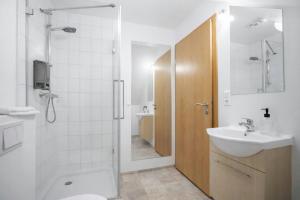 a bathroom with a sink and a toilet and a shower at Malarhorn Accommodations in Drangsnes