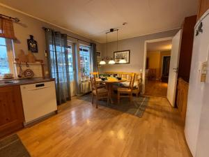 a kitchen and dining room with a table and chairs at Aspudden en pärla i Sörmland in Vingåker