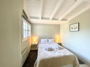 a bedroom with a bed and a window and two lamps at Aggelou Apartments-10 mins from Athens airport in Spata