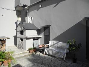 a patio with a chair and a fireplace on a building at Flat26 in Castiglion Fiorentino