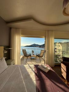 a bedroom with a bed and a view of the ocean at Meridian Hotel in Budva