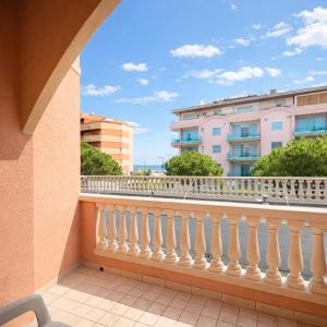 a balcony with a white railing and buildings at Hotel Fiamma & SPA Cesenatico in Cesenatico