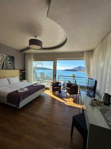 a bedroom with a bed and a desk with a television at Meridian Hotel in Budva