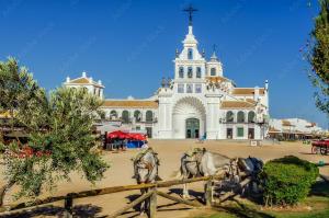 a horse drawn carriage in front of a building at CENTER APARTMENT Mazagón in Mazagón