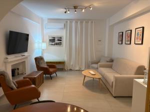 a living room with a couch and a tv at HOMES By PALUMBO in Prunella