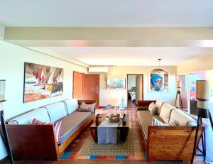 a living room with a couch and a table at Villa Les Agaves front de mer in Le François
