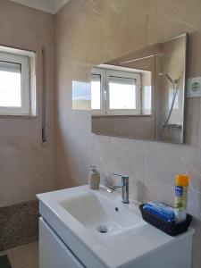 a bathroom with a sink and a mirror at Casa da Eira - Alojamento Local in São João da Pesqueira