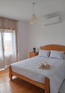 a bedroom with a bed with a towel on it at Casa da Eira - Alojamento Local in São João da Pesqueira