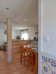 a kitchen and dining room with a table and chairs at Casa da Eira - Alojamento Local in São João da Pesqueira +15 photos