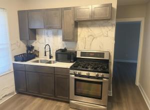 a kitchen with a stove and a sink at City Retreat in Chicago