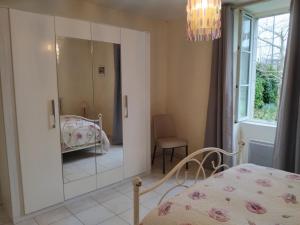 a bedroom with a mirror and a bed in it at Roz Aon in Châteauneuf-du-Faou