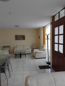 a living room with white couches and a table at Roz Aon in Châteauneuf-du-Faou +4 photos