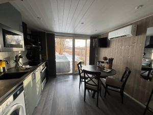 a kitchen and dining room with a table and chairs at TinyHouze in Karlskrona +18 photos