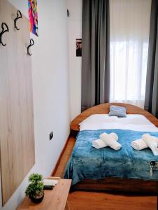 a bedroom with a bed with two towels on it at GuestHouse5 KARMA369 in Plovdiv