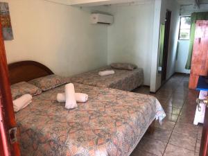 a room with two beds in a room at Casa Rector - Beach House Rental in El Roble