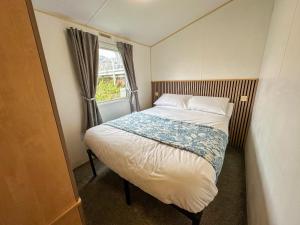 a small bedroom with a bed and a window at The Bay Hideaway in Bucks Mills +19 photos