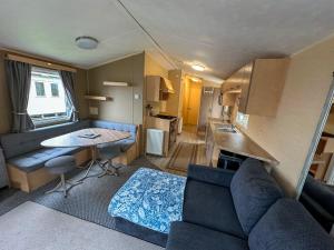 a living room with a couch and a table in a caravan at The Bay Hideaway in Bucks Mills