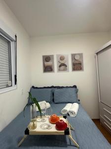 a bedroom with a bed with a tray of food on it at Apartamento completo em Ponta de Campina, 2 quartos, piscina, academia e Wi-Fi in Cabedelo +20 photos