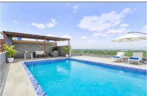a swimming pool on the roof of a house at Mangal Hotel & Resorts Pool in Udaipur