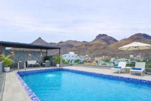 a swimming pool with a view of the mountains at Mangal Hotel & Resorts Pool in Udaipur