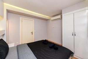 a bedroom with a bed with two black shoes on it at İstanbul Amoria Guest House in Istanbul +28 photos