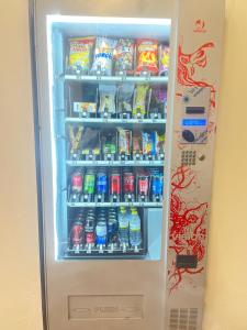 a refrigerator filled with lots of soda and snacks at Hotel Rural La Fuentecilla in Algatocín