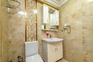 a bathroom with a toilet and a sink and a mirror at İstanbul Amoria Guest House in Istanbul