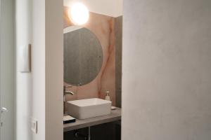 a bathroom with a sink and a mirror at Atmosfere 21 in Pagani