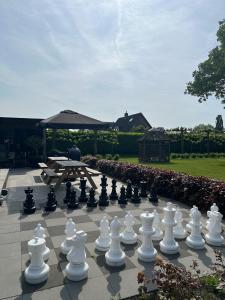 a large chessboard on a patio with a table at Bed and Breakfast Roodkapje in Kaatsheuvel