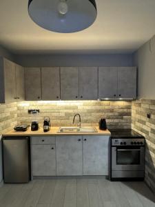 a kitchen with a sink and a stove at Fabulous Villa in Monemvasia