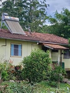 a house with a solar panel on the roof at Casa Amarela in Bocaina de Minas +12 photos