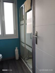 a bathroom with a glass shower door and a toilet at Errekaondo in Areatza +17 photos