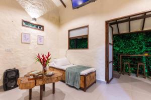 a room with a bed and a table and a window at Eco Lodge Glamping in Guatapé
