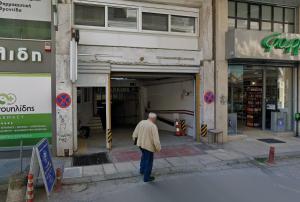 an older man walking into a building at Galleria Home in Serres