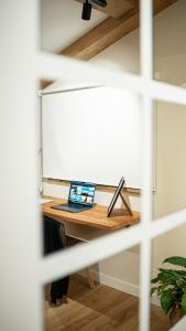 a desk with a laptop computer on top of it at iSlow Costa da Morte in Laxe