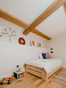 a bedroom with a bed in a room with wooden floors at iSlow Costa da Morte in Laxe