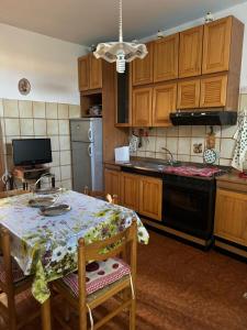 a kitchen with a table and a stove top oven at Casa di Anna in Graffignano