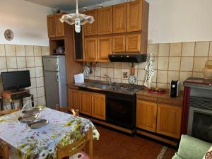 a kitchen with wooden cabinets and a table with a table sidx sidx sidx at Casa di Anna in Graffignano