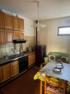 a kitchen with a table and a stove top oven at Casa di Anna in Graffignano