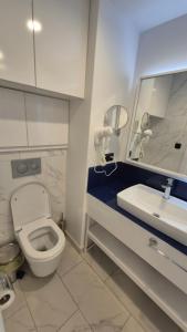 a bathroom with a toilet and a sink and a mirror at best VIP HOTEL panorama suites IN batumi R in Batumi +42 photos