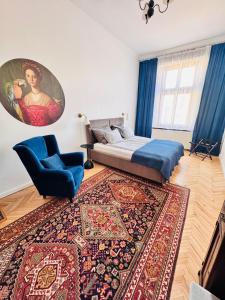 a bedroom with a bed and a chair and a rug at Apartament Rynek 20 in Krosno