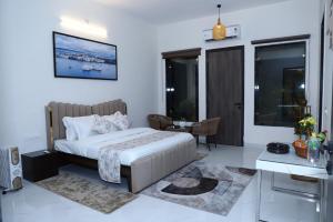 a bedroom with a bed and a desk in it at Nesara the nature villa in Jāmb +28 photos