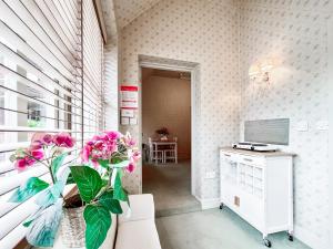 a room with a vase with pink flowers in it at Cottage 1 - Uk46611 in Broughton +13 photos
