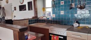 a kitchen with a sink and a stove at Il Nido Nel Bosco in Motta +7 photos