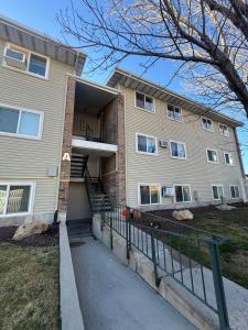 a apartment building with a staircase in front of it at Cozy blue house in Salt Lake City
