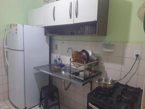 a kitchen with a white refrigerator and a counter top at Ambiente Familiar in Alagoinhas