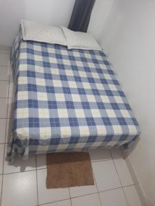 a blue and white mattress sitting on a floor at Ambiente Familiar in Alagoinhas
