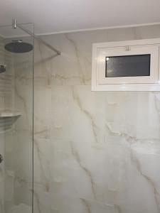 a bathroom with a television on a wall at Sarakinas Farm House in Kalabaka +37 photos