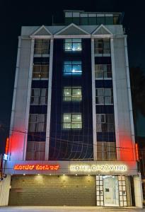 a building with red lights in front of it at Hotel Cozzy Inn in Bangalore