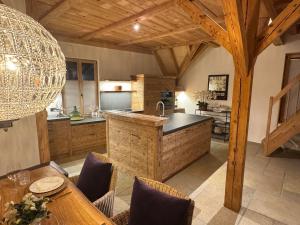 a kitchen with a large island in a room at Black Cockatoo Lodge close to Bern and Thun in Oberdiessbach